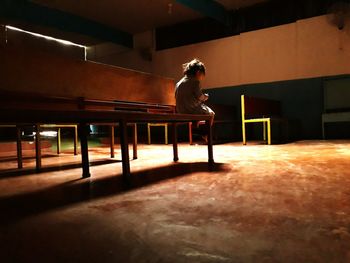 Rear view of girl sitting on bench