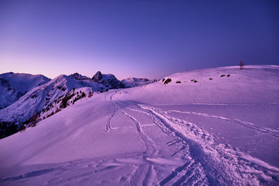 Scenic view of snow covered mountains against clear sky