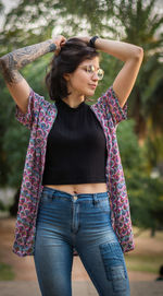 Young woman with hand in hair standing outdoors