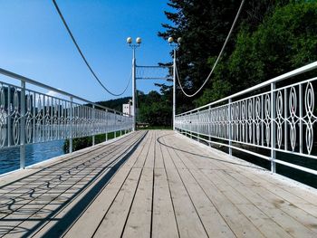 Empty footbridge against clear sky