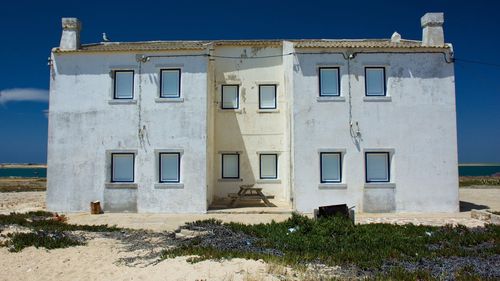 Low angle view of abandoned house against clear sky