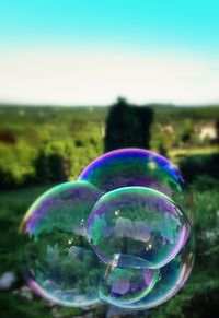 Close up of bubbles on field against blue sky