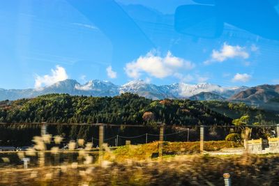 Scenic view of mountains against blue sky