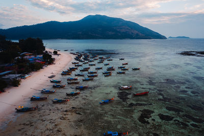 Scenic view of sea and mountains against sky