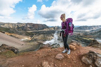 Female backpacker observes laugahraun lava flow field