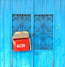 Mailbox on closed blue door