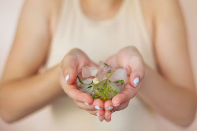 Close-up of woman hand holding plant