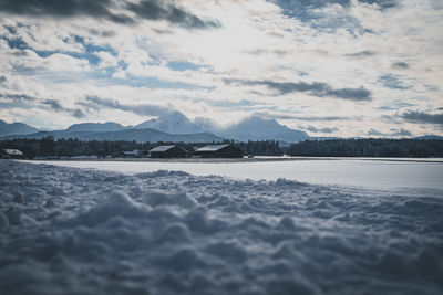 Scenic view of lake against sky during winter