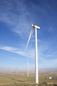 Windmill on field against sky