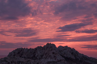 Rock formation against sky during sunset