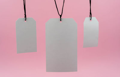 Close-up of paper hanging against wall