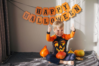A little boy in a pumpkin costume for halloween, trick or treat. children celebrate