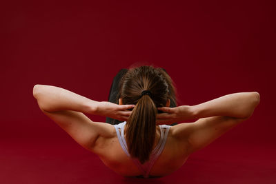 Woman goes in for sports on a red background