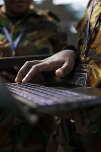 Midsection of woman using laptop