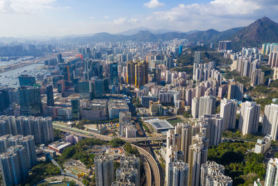 High angle view of modern buildings in city against sky