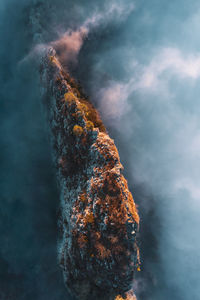 High angle view of mountain ridge rising above the clouds, hallein, austria.