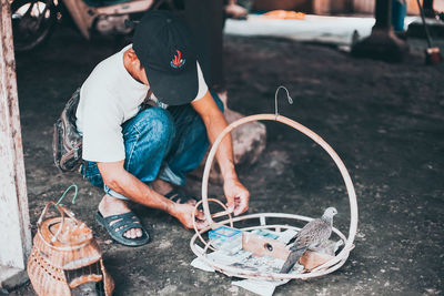 Low section of people working on motorcycle