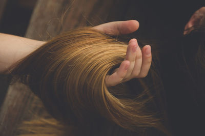 Close-up of human hand holding hair