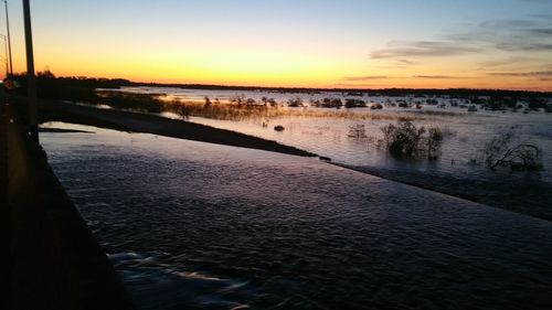 Scenic view of river at sunset