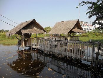 Gazebo by lake against clear sky