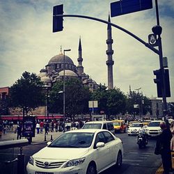 Traffic on road in city against sky