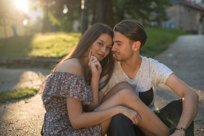 Young couple sitting outdoors