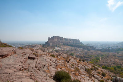 Rock formations on landscape against sky