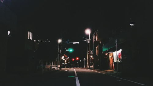 Illuminated road in city at night