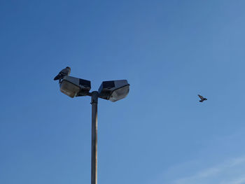 Low angle view of street light against clear blue sky