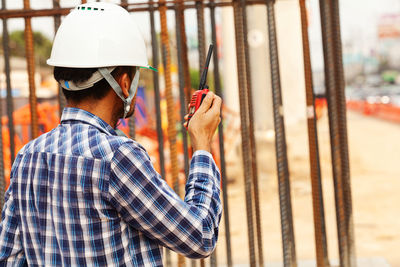 Rear view of man working at construction site