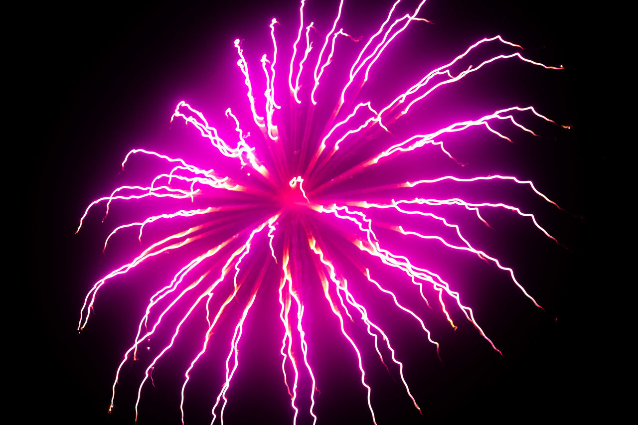 LOW ANGLE VIEW OF FIREWORKS IN SKY