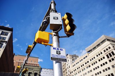 Low angle view of road sign against sky