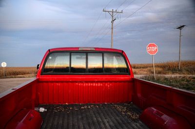 Red road against sky during sunset