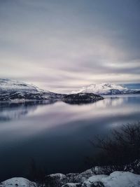 Scenic view of frozen lake against sky during winter