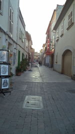 Empty alley amidst buildings in city