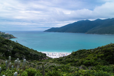 Scenic view of sea and mountains against sky