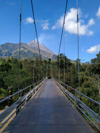 Footbridge over road against sky