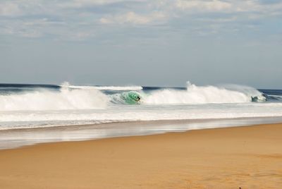 Scenic view of sea waves against sky