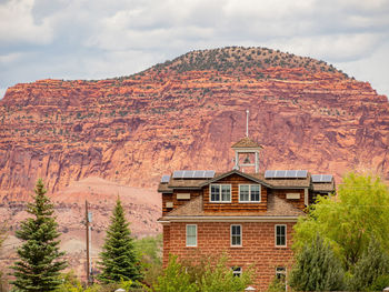 House on mountain against sky