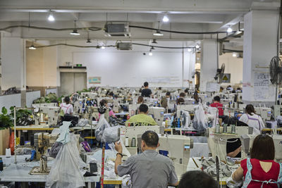 View of busy sewing room in chinese shoes factory