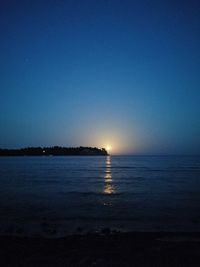 Scenic view of sea against clear sky at sunset