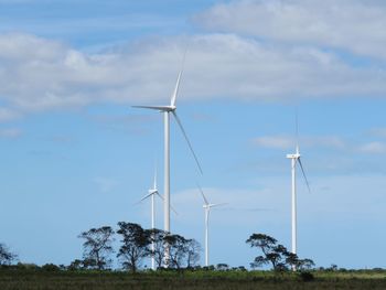 Windmill on field against sky