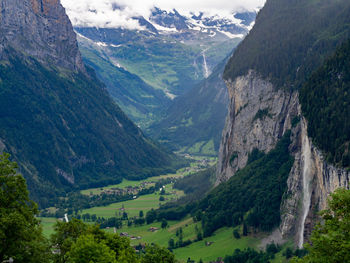 Scenic view of valley and mountains against sky