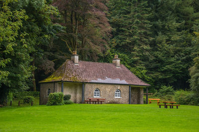 House on field by trees