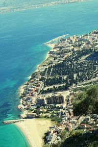 High angle view of sea and cityscape against sky