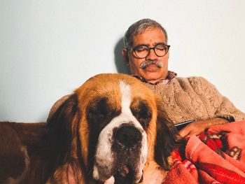 Portrait of man with dog at home