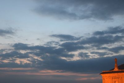 Low angle view of built structure against cloudy sky