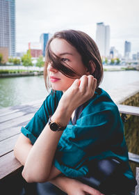 Portrait of young woman sitting outdoors