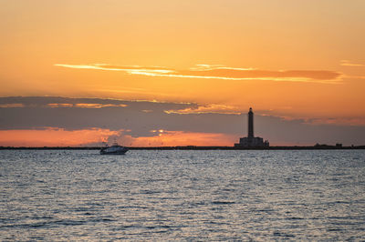 Scenic view of sea against orange sky