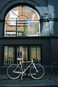 Bicycle parked in front of building